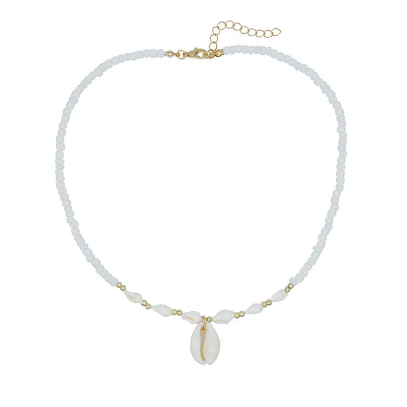 White necklace with a mother of pearl conch shell pendant and beads on an electroplated chain.