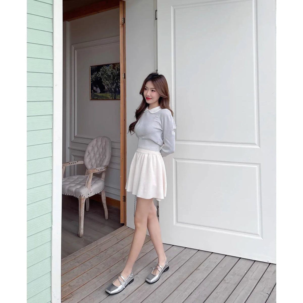 Women's silver leather ballet pumps with a cross buckle strap and flat heel