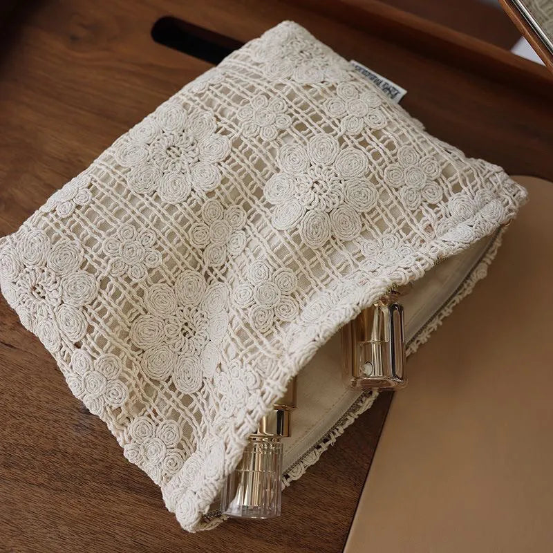 Handmade corduroy cosmetic bag with crocheted hollow flower and ethnic embroidery design.