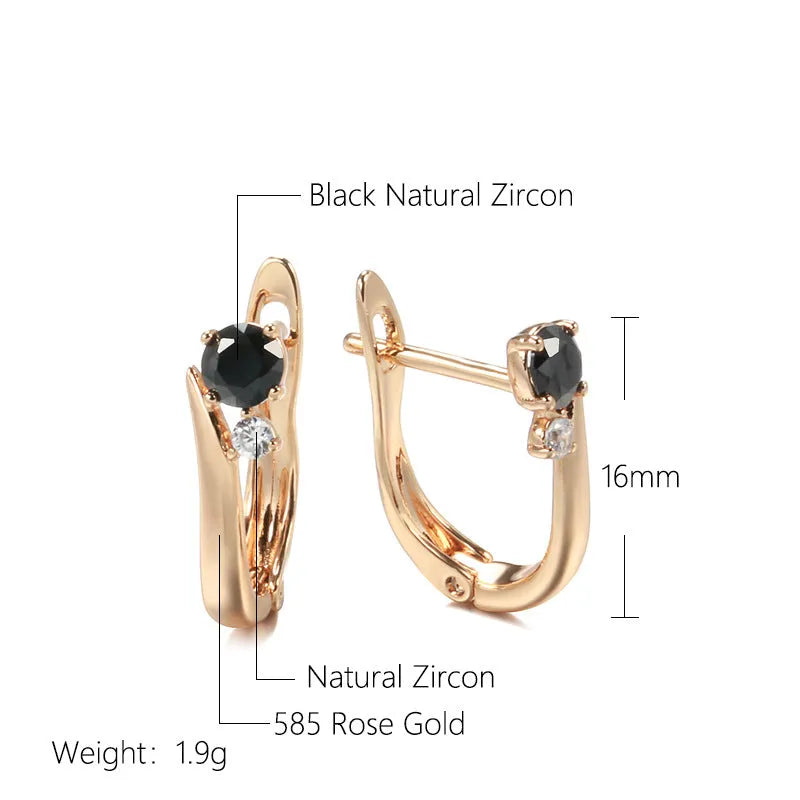 Gold geometric drop earrings with artificial gemstone inlay on black background