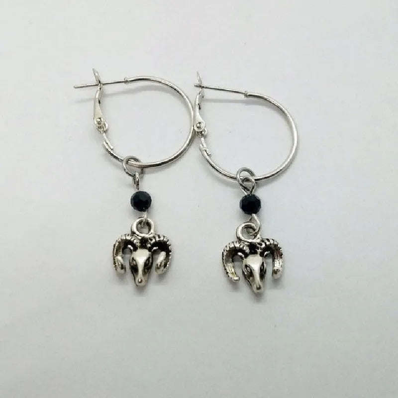 A pair of silver-coloured alloy round ring earrings with Tibetan antelope design inspiration.