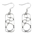 A pair of geometric round earrings with an irregular square shape in antique silver finish.