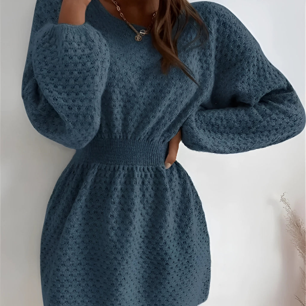 Blue women's knitted dress with crocheted flowers, a round neck, and a fitted waist.