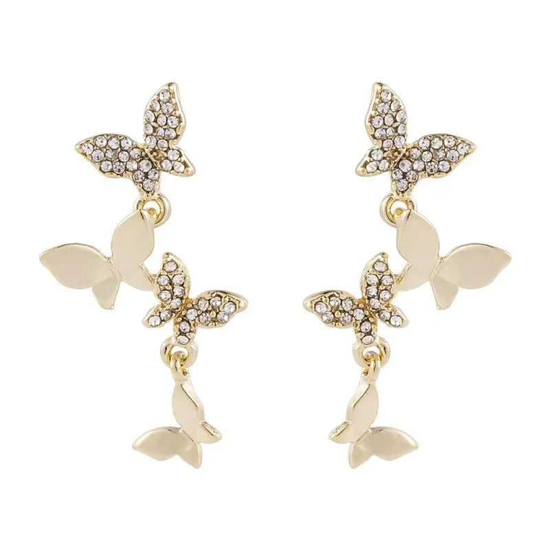 A pair of gold-coloured copper earrings with four detailed butterfly designs in a drop style.