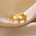 Geometric titanium steel women's ring with gold diamond finish shown on hand