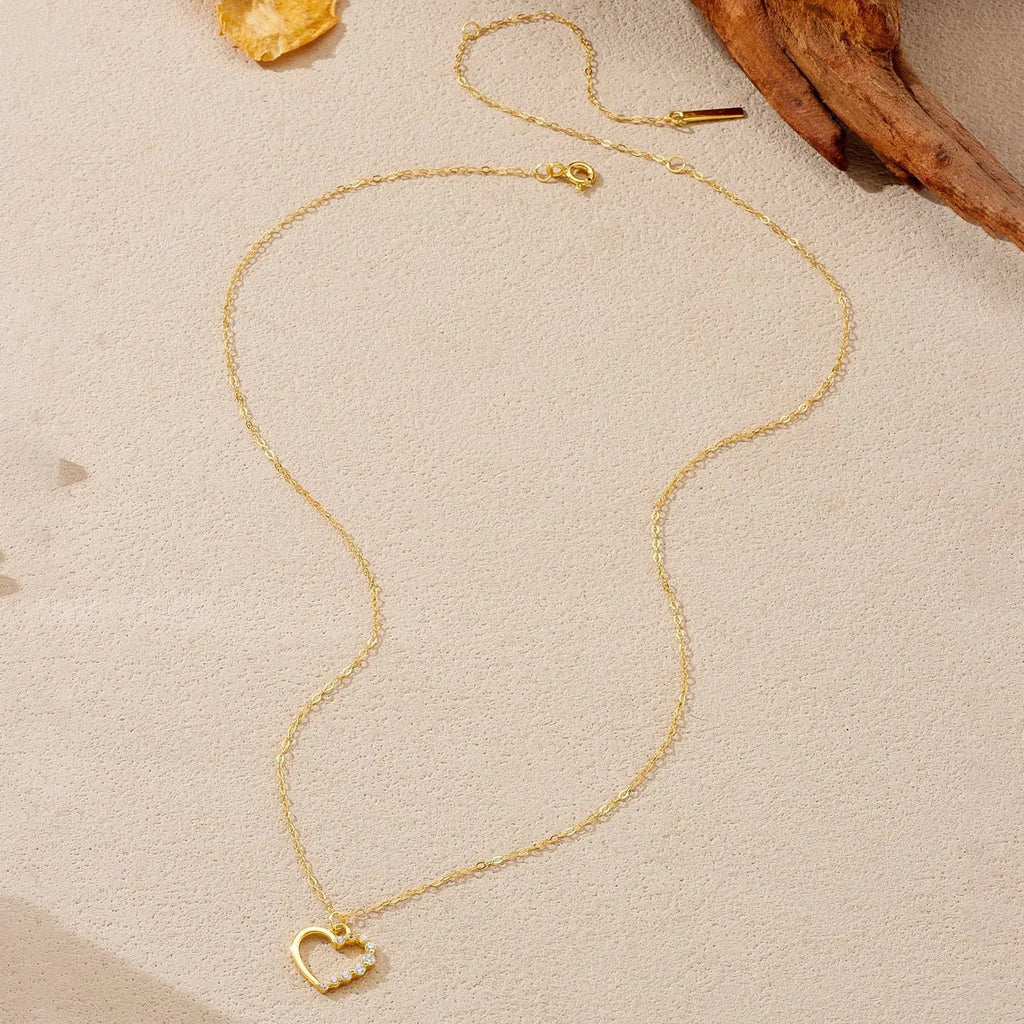 S925 sterling silver hollow heart pendant necklace on a chain with a gold plated finish.