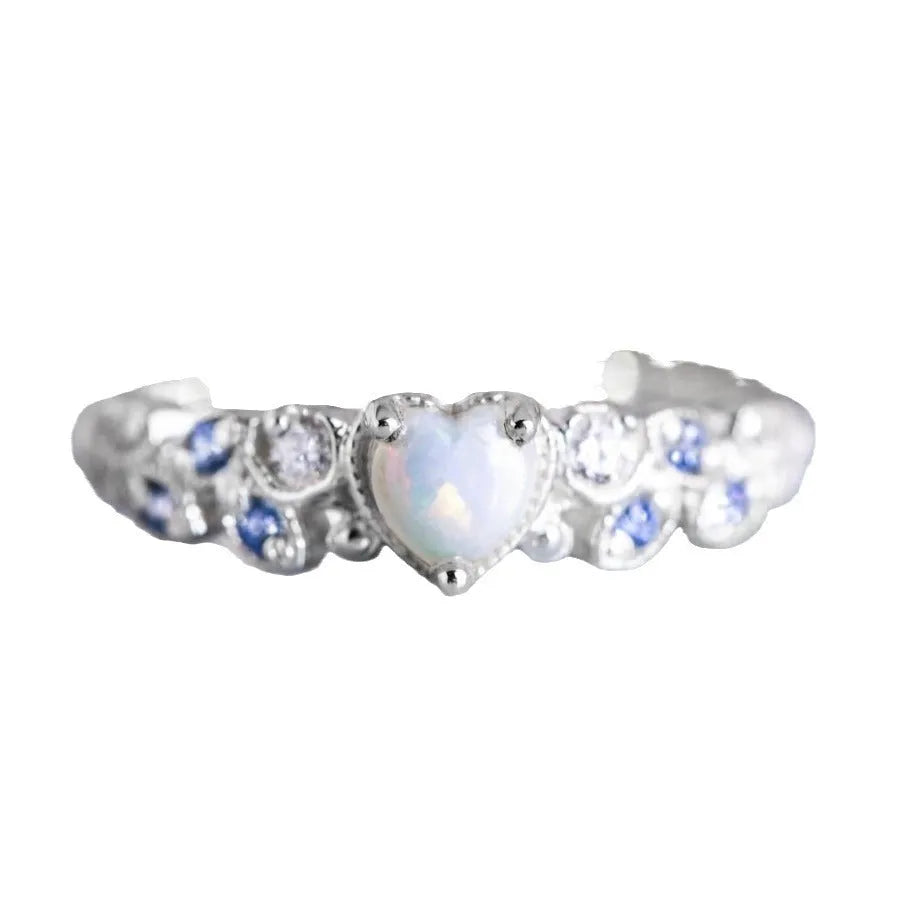 Women's white alloy heart ring with flower opal ocean design shown in UK size 10
