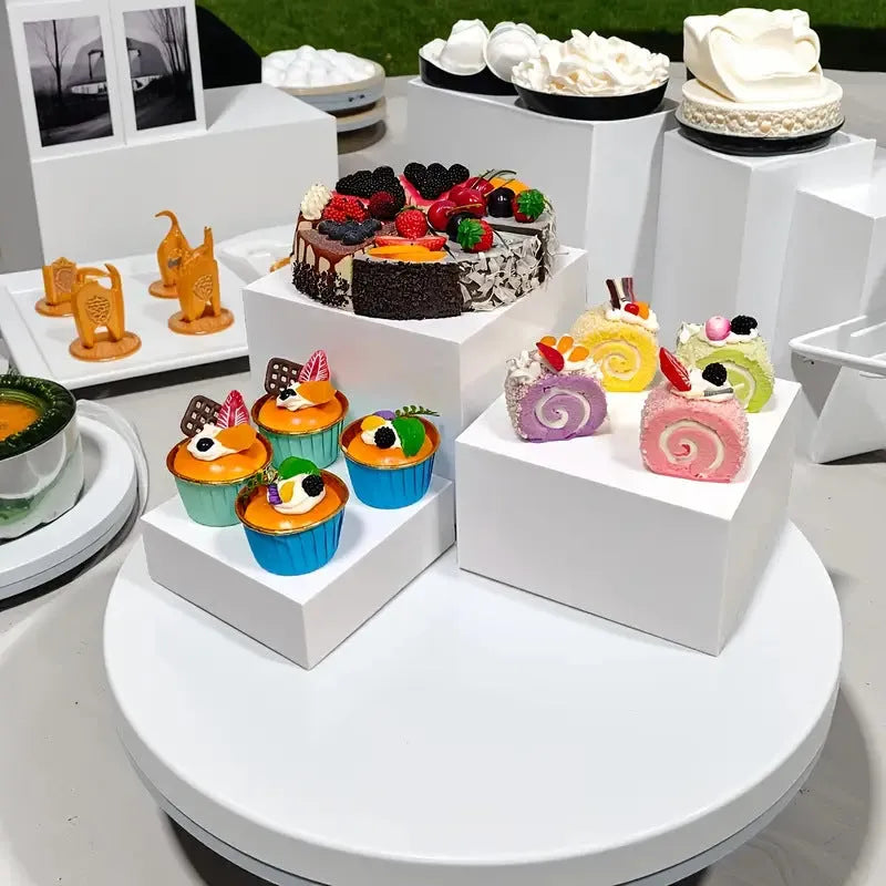 White plastic Suit Cube dessert display stand with six modular pieces arranged in multi-level configuration