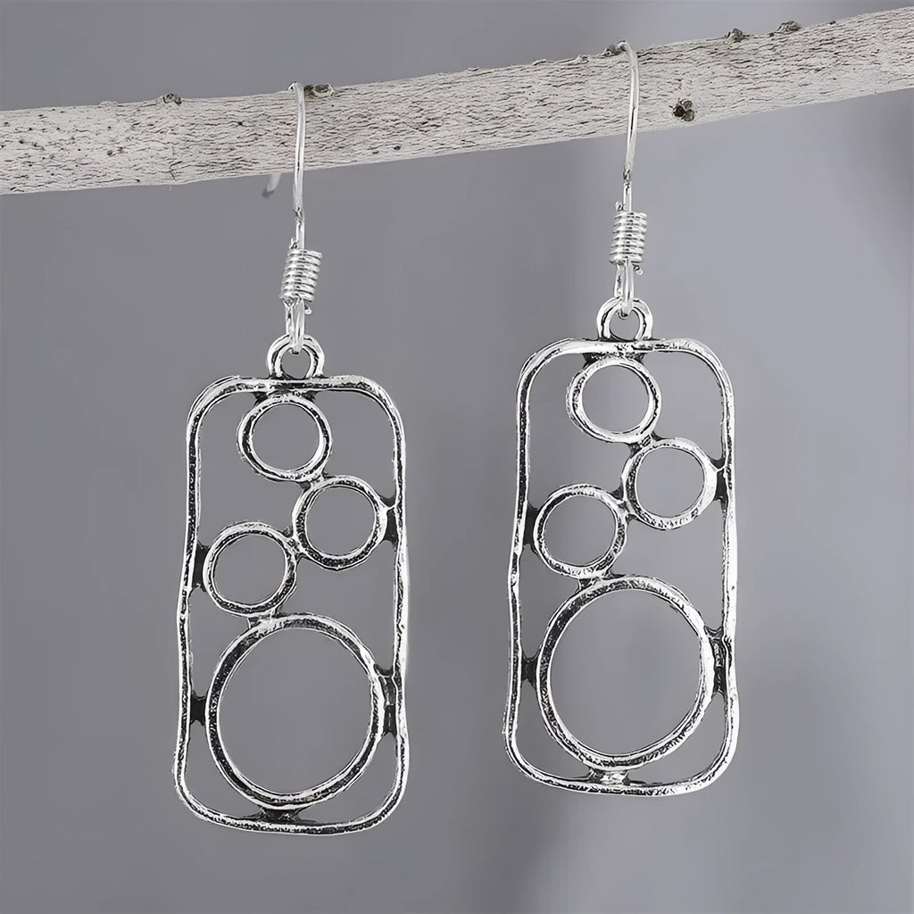 A pair of geometric round earrings with an irregular square shape in antique silver finish.