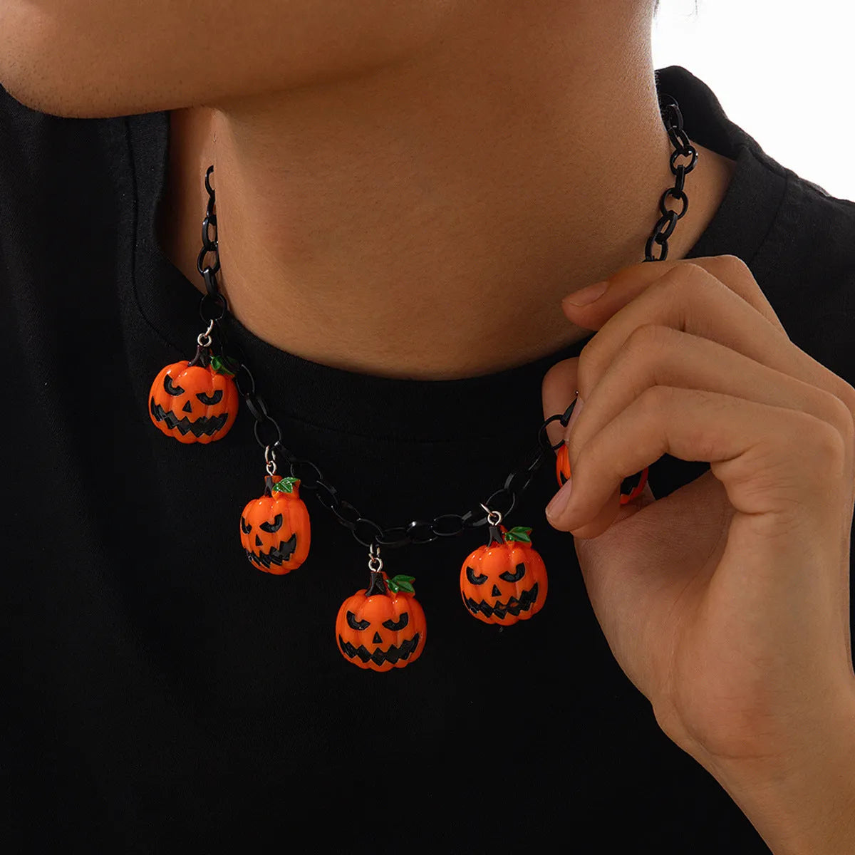 Cartoon pumpkin Halloween necklace with mixed colour acrylic pendant on a regular chain.