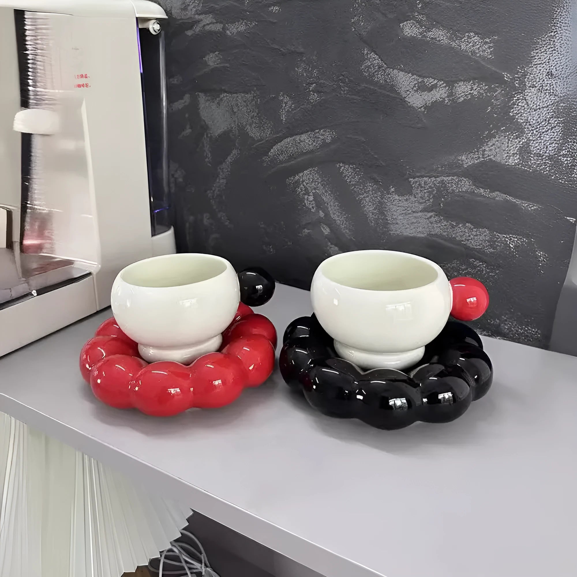 Ceramic coffee cup and saucer set in a solid colour on a wooden table.