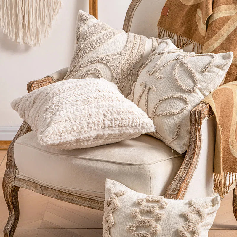 Knitted cushion cover with tassel fringe in a striped pattern, shown in spiral dots design.