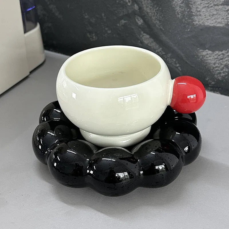 Ceramic coffee cup and saucer set in a solid colour on a wooden table.