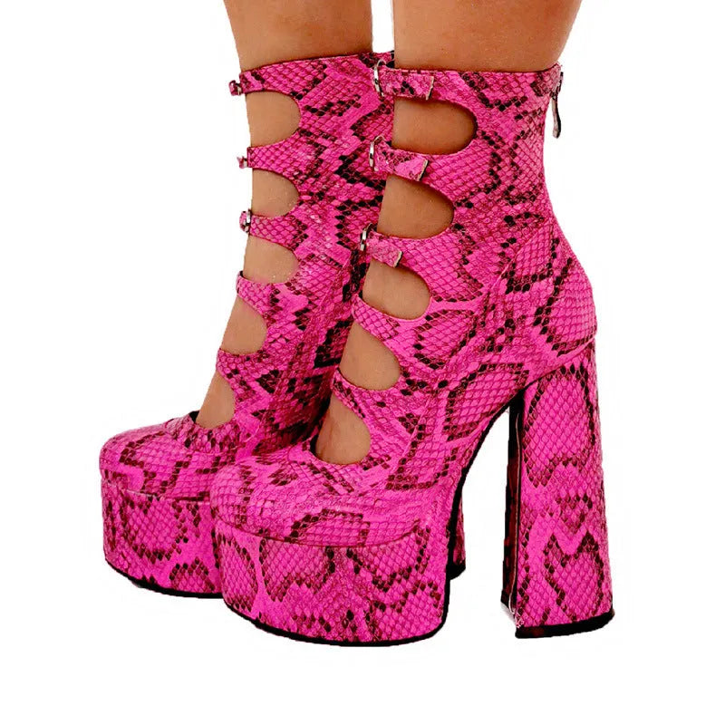 Women's black patent leather platform high heels with a thick serpentine ankle strap and buckle fastening.