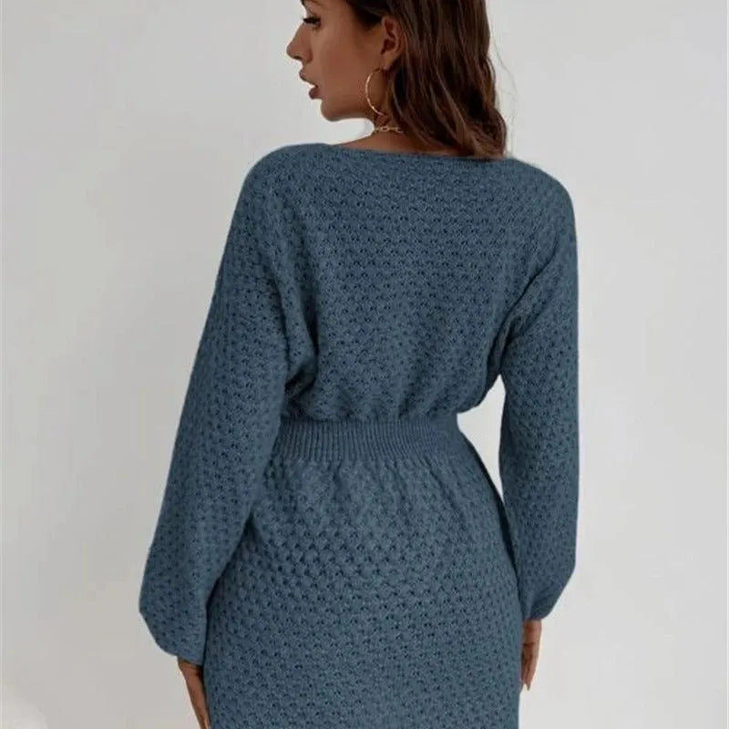 Blue women's knitted dress with crocheted flowers, a round neck, and a fitted waist.