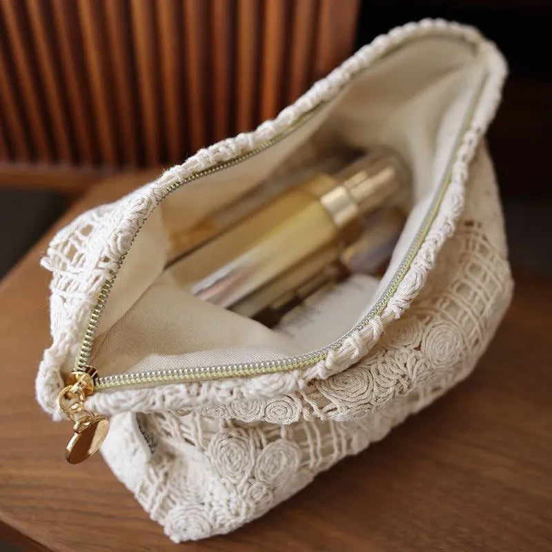Handmade corduroy cosmetic bag with crocheted hollow flower and ethnic embroidery design.
