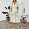 Light green women's shirt dress with lapel collar, waist tie, and side pockets