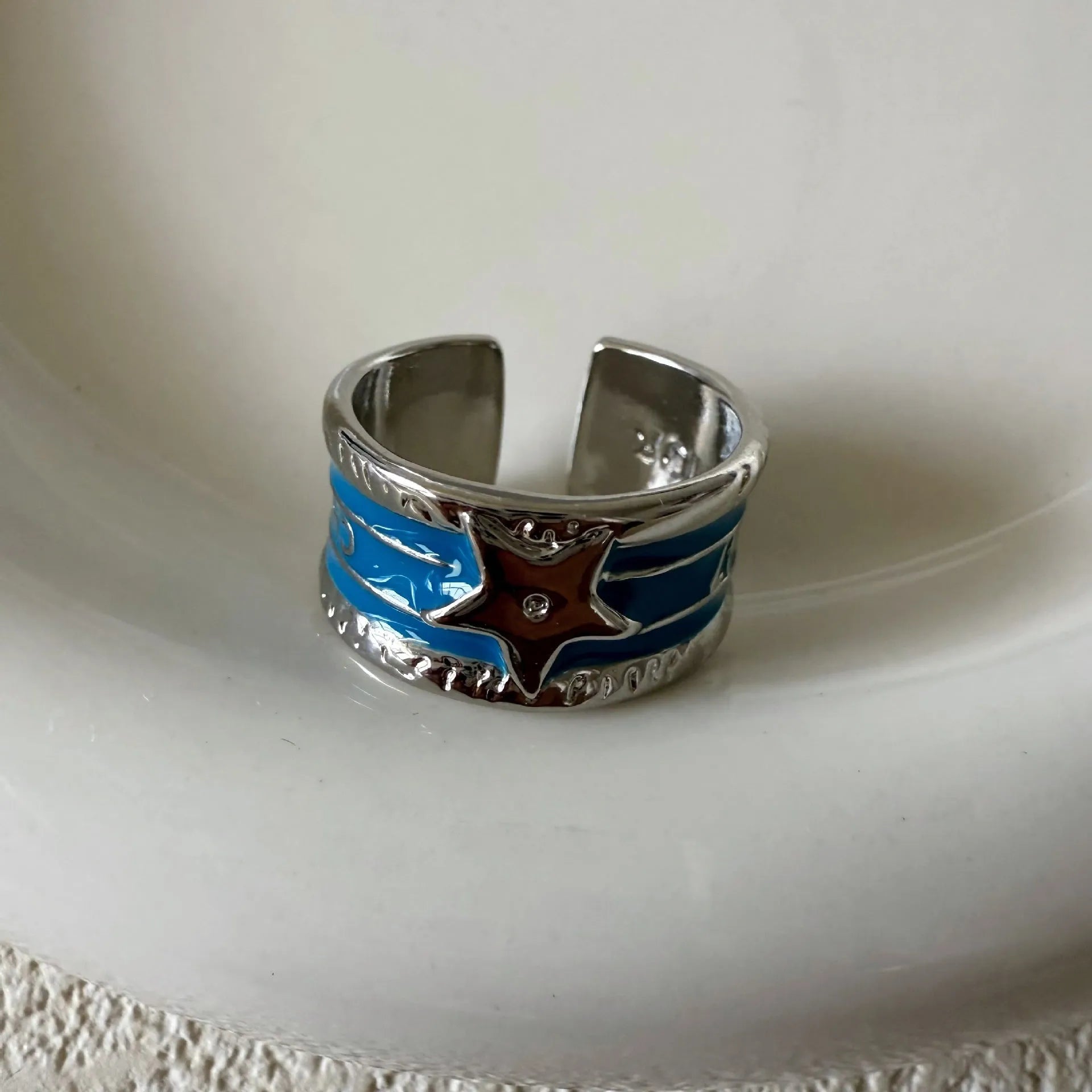 Adjustable geometric copper ring with distressed finish and XINGX drop oil design in selected colour.