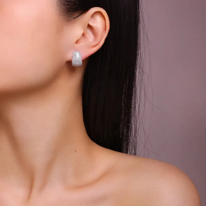 Geometric women's ear studs in sterling silver with white moissanite stones.