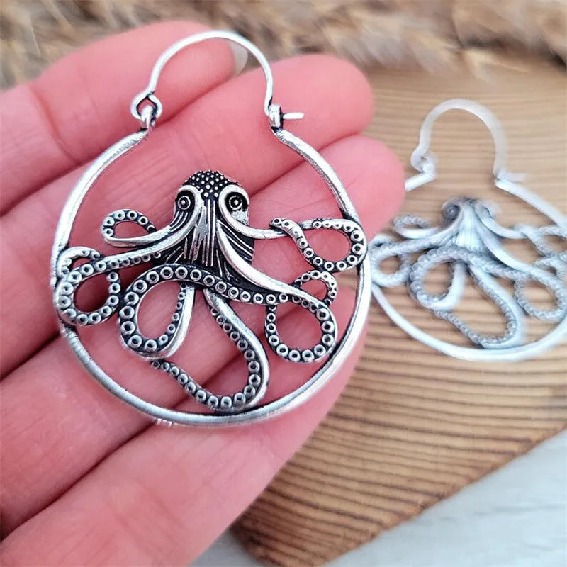 A pair of vintage antique silver octopus earrings with detailed animal modelling and a retro style.