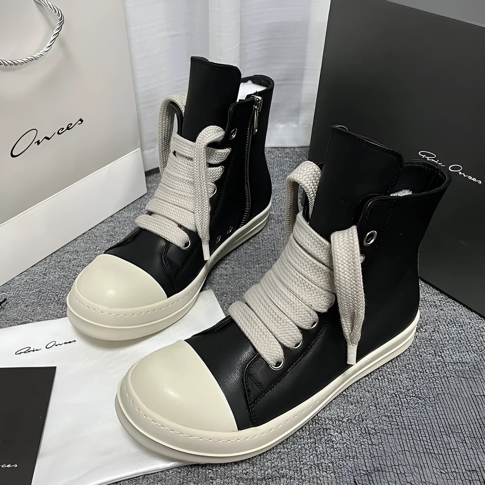 Black genuine leather high-top sneakers with a side zipper and round toe on a rubber platform sole.