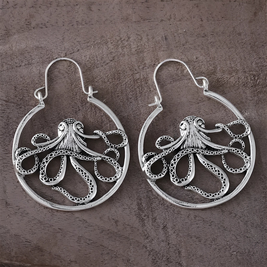 A pair of vintage antique silver octopus earrings with detailed animal modelling and a retro style.
