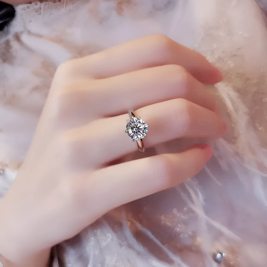 White gold plated six-claw zircon ring on a geometric white copper band.