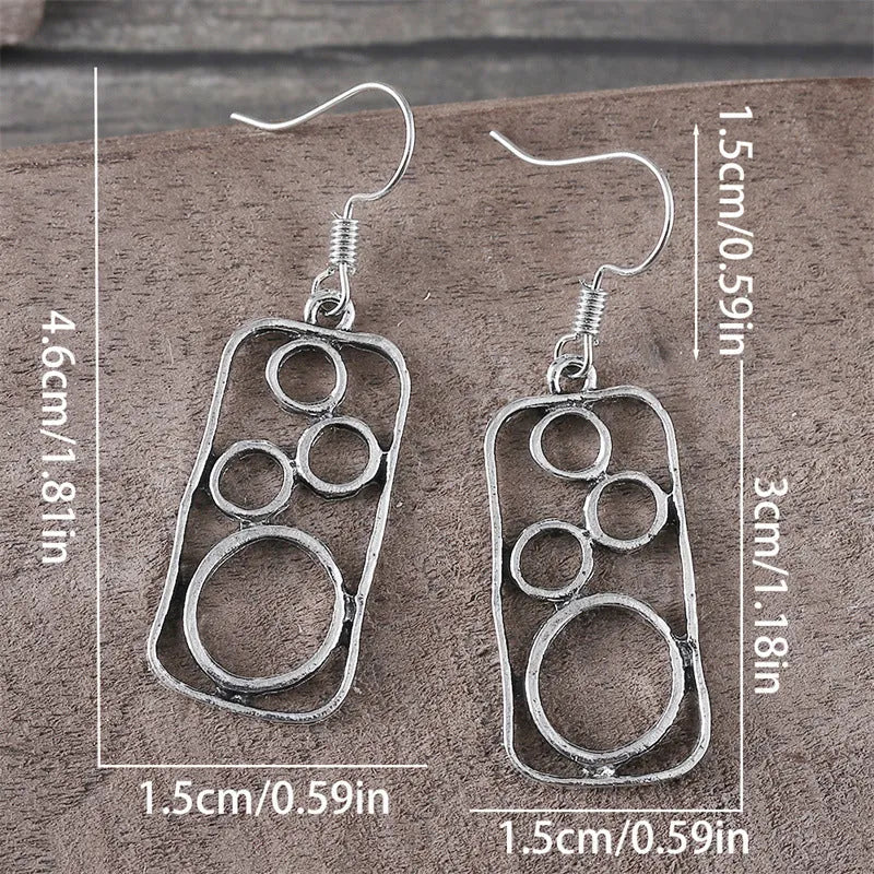 A pair of geometric round earrings with an irregular square shape in antique silver finish.