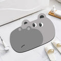 Cartoon animal diatomaceous earth bathroom mat in alien shape on a bathroom floor.