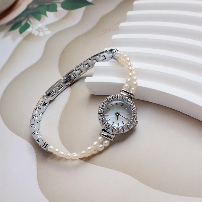 Women's light gold bracelet watch with freshwater pearls and 18mm round dial