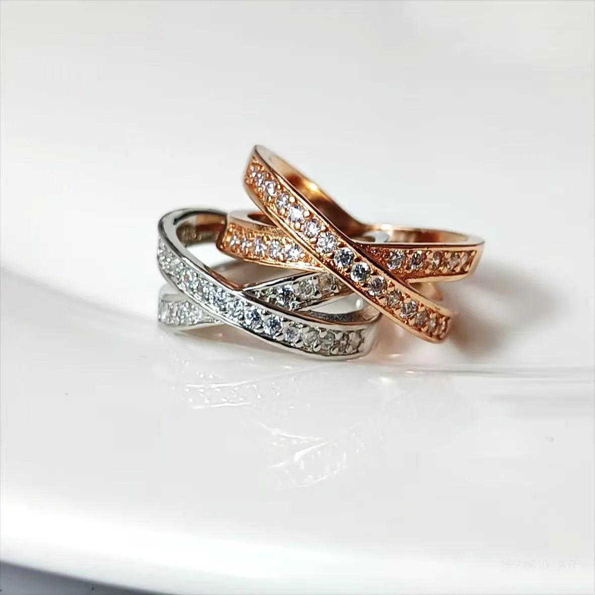 Silver and rose gold metal cross ring with micro-inlaid zircon detailing in heart and geometric design