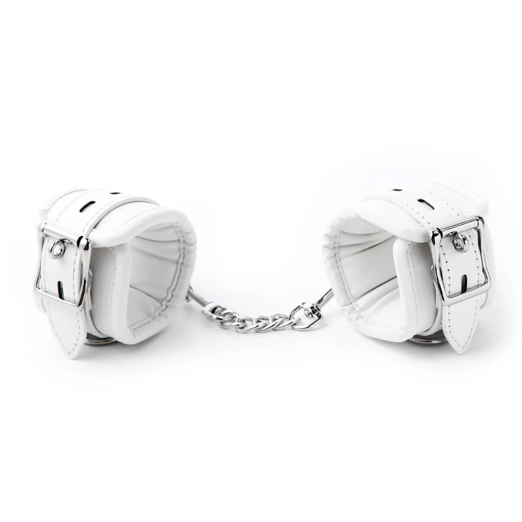 White PU sponge bondage restraint set showing handcuffs, foot cuffs, and a neck scarf.