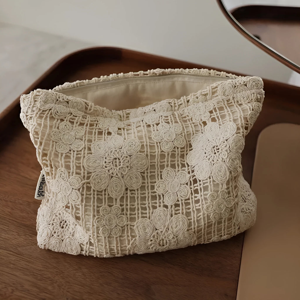 Handmade corduroy cosmetic bag with crocheted hollow flower and ethnic embroidery design.
