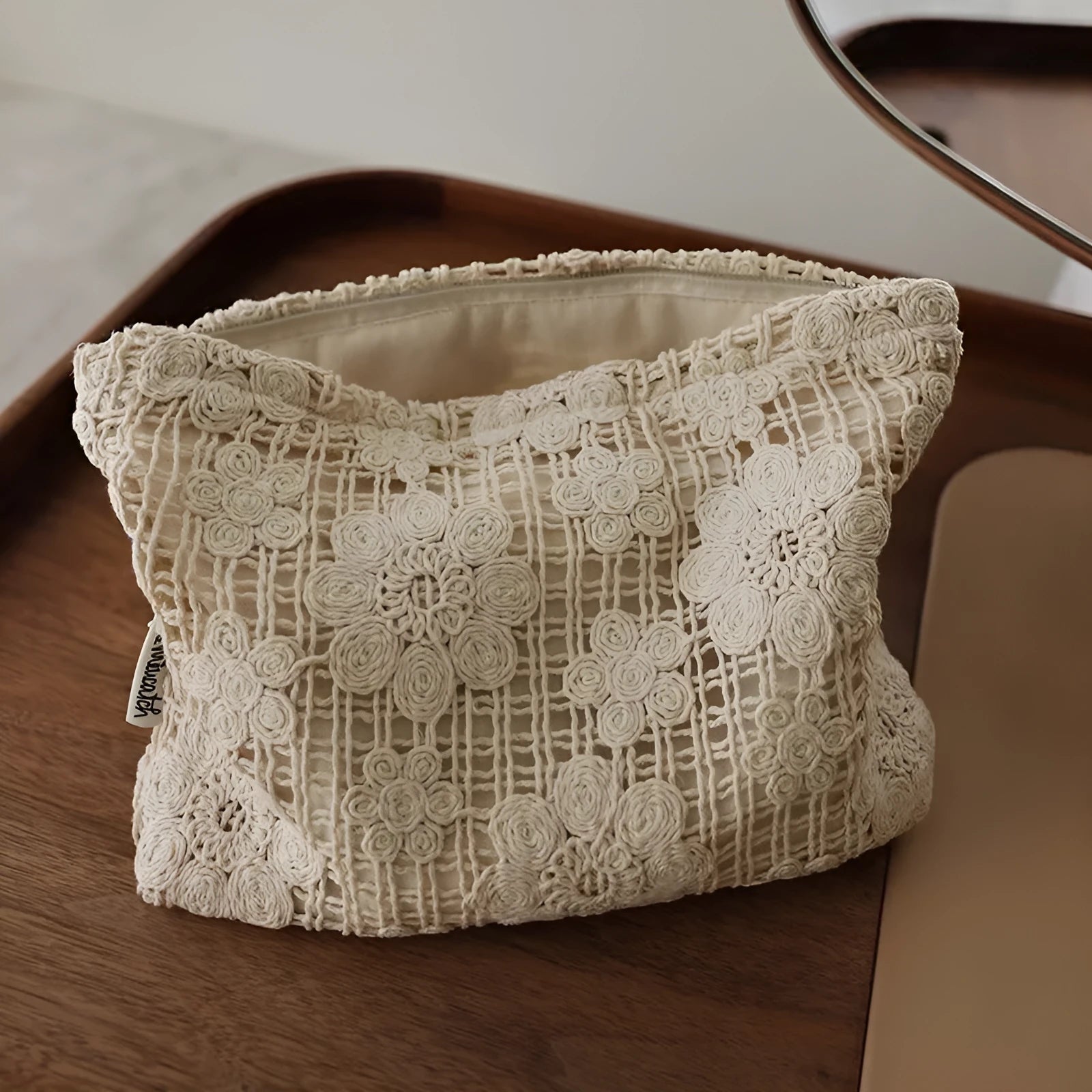 Handmade corduroy cosmetic bag with crocheted hollow flower and ethnic embroidery design.