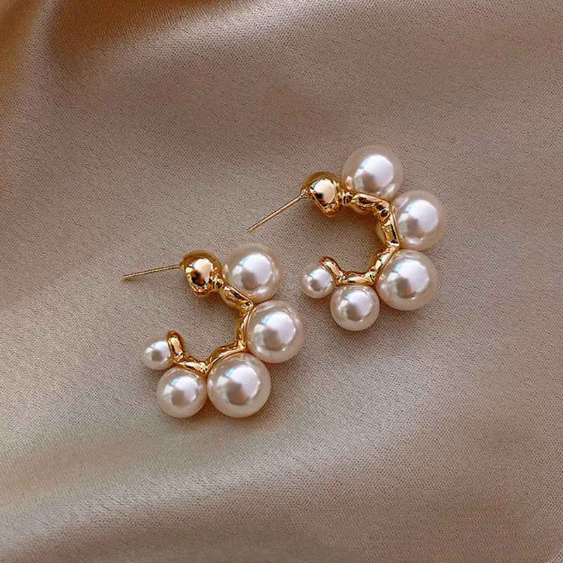 A pair of red bell-shaped alloy earrings for women on a white background.