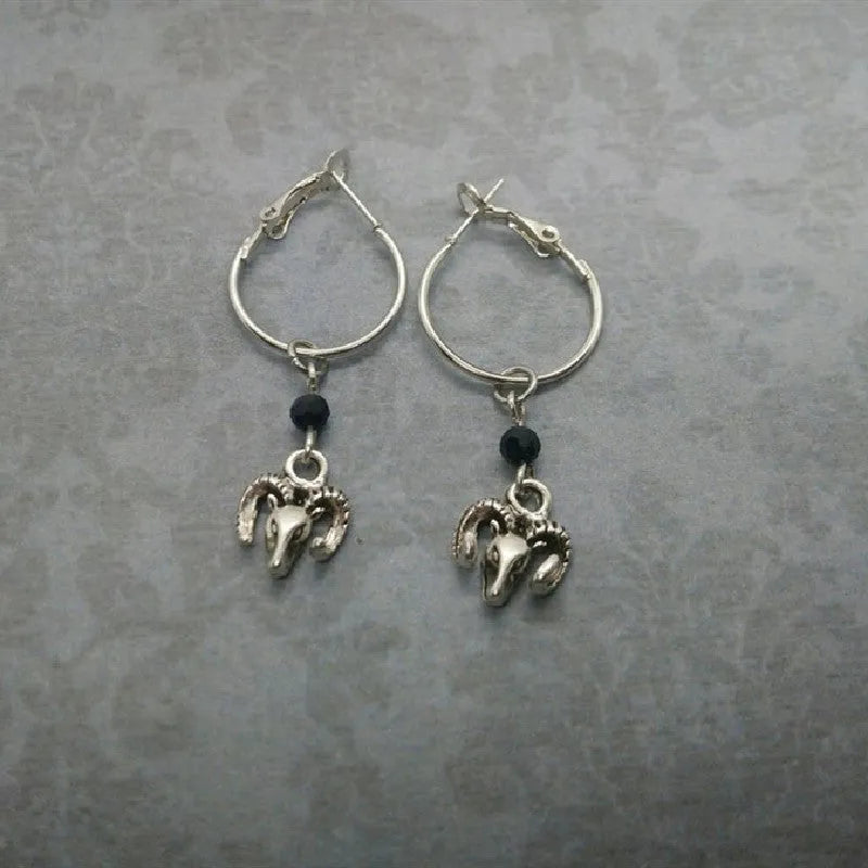 A pair of silver-coloured alloy round ring earrings with Tibetan antelope design inspiration.