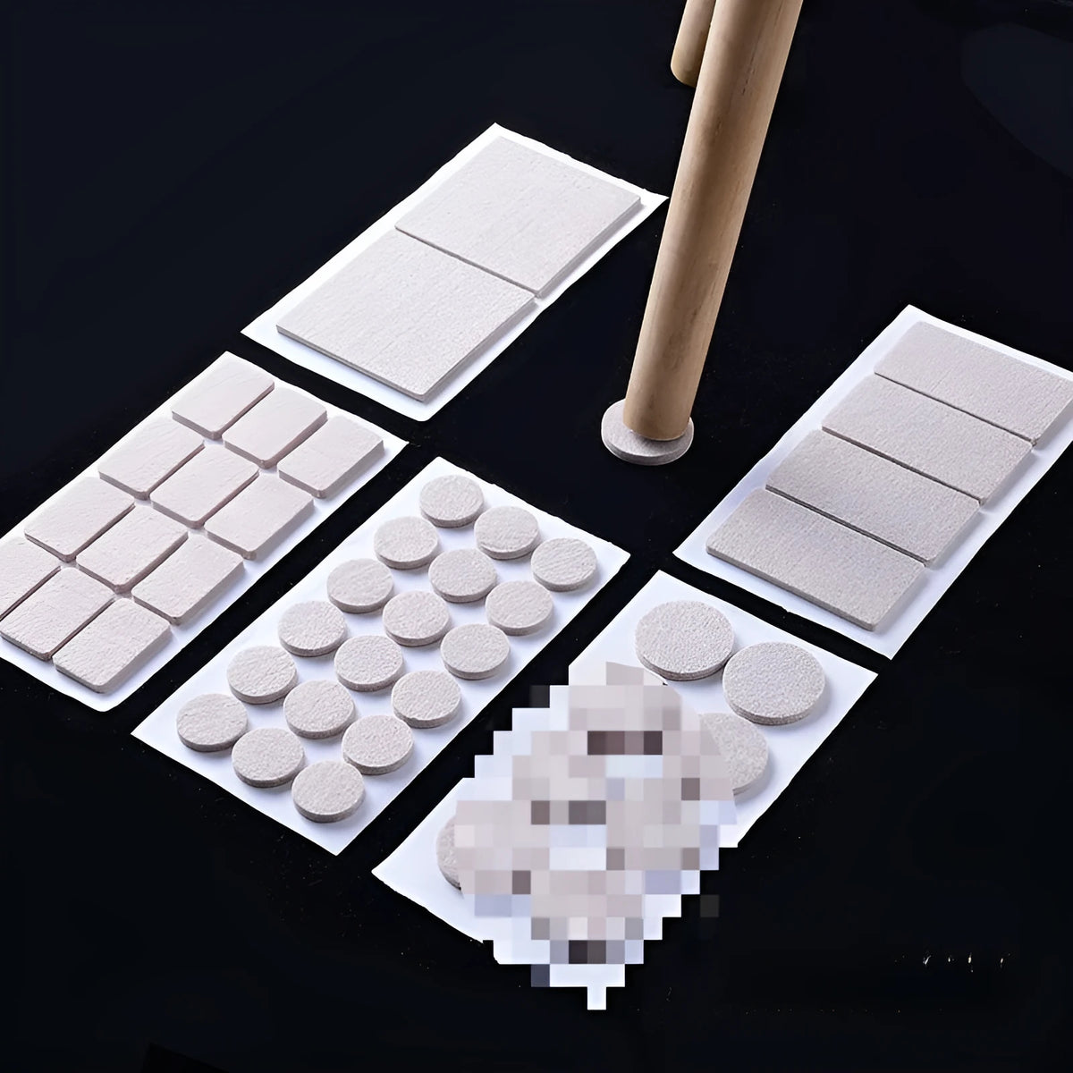 Beige plastic furniture leg stopper pads in five different sizes on a wooden floor