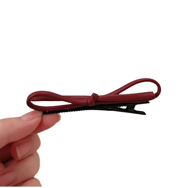 Wine red leather bow barrettes hair clips showing handcrafted bow design