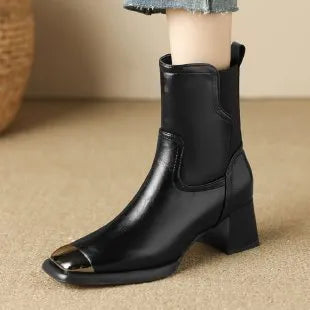 Women's brown cowhide Martin boots with high heel and side zipper, featuring decorative metal elements
