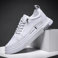 Men's black and white low-top skate shoes with elastic band fastening and rubber sole.