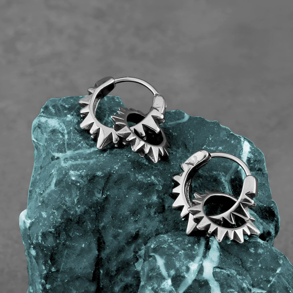 A pair of polished stainless steel round ring earrings with a titanium steel plating in a steel colour.