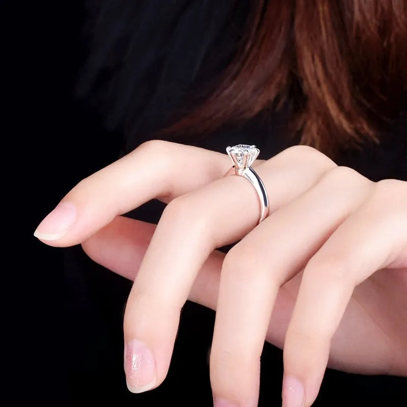 White gold plated six-claw zircon ring on a geometric white copper band.
