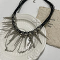 Leather necklace with round beads and winding tassel design featuring point rivet details