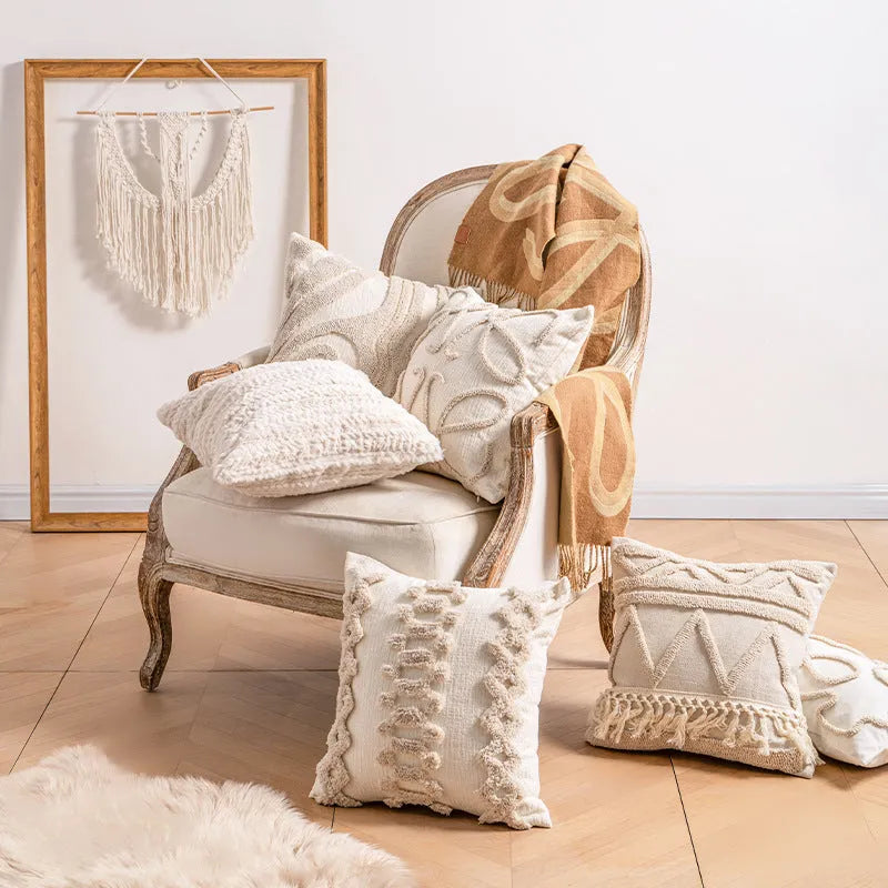 Knitted cushion cover with tassel fringe in a striped pattern, shown in spiral dots design.