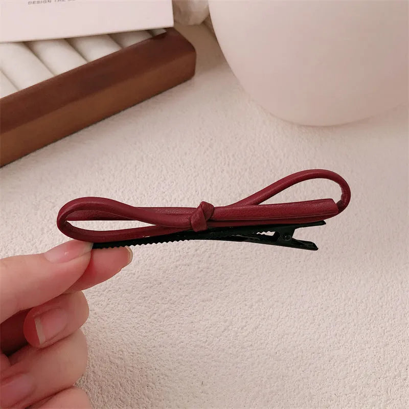 Wine red leather bow barrettes hair clips showing handcrafted bow design