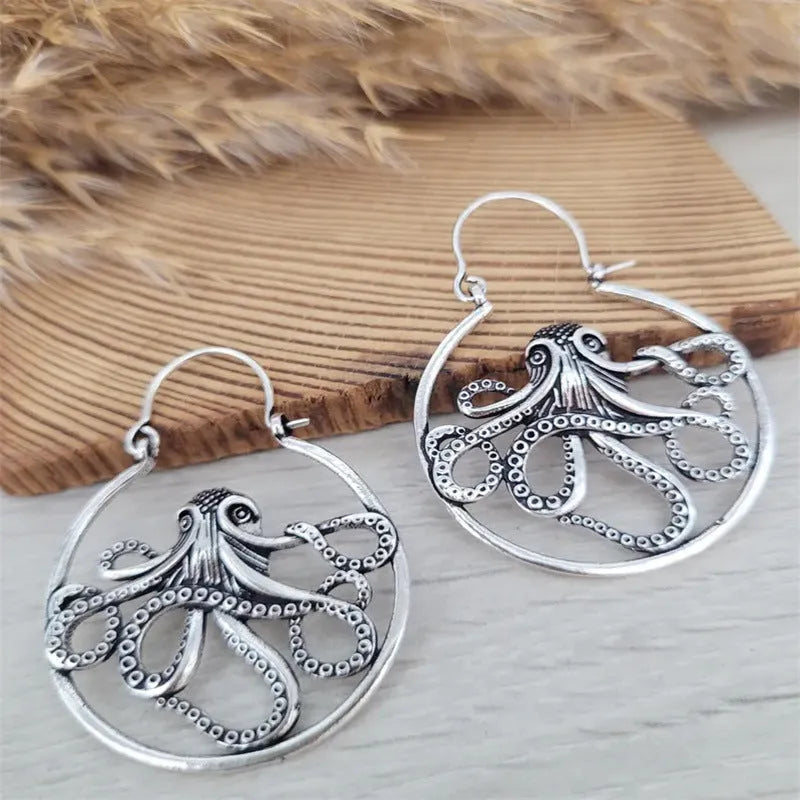 A pair of vintage antique silver octopus earrings with detailed animal modelling and a retro style.