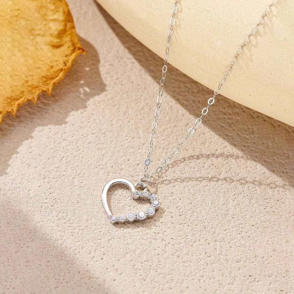 S925 sterling silver hollow heart pendant necklace on a chain with a gold plated finish.