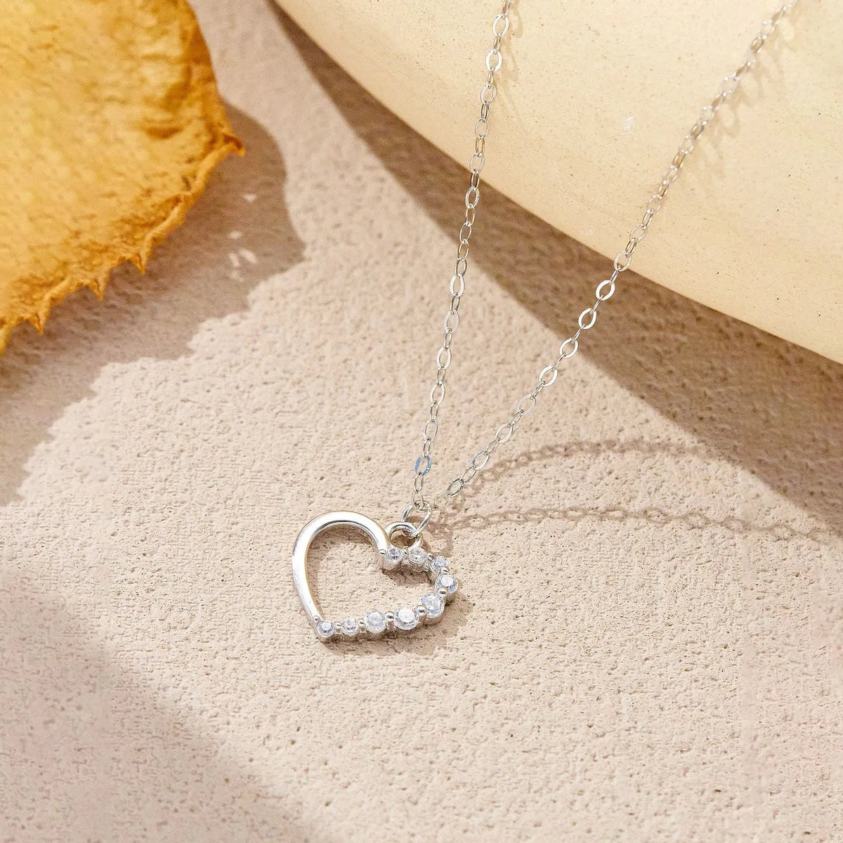 S925 sterling silver hollow heart pendant necklace on a chain with a gold plated finish.