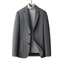 Men's slim fit wool suit jacket in grey, shown on a model, suitable for autumn and winter leisure wear.