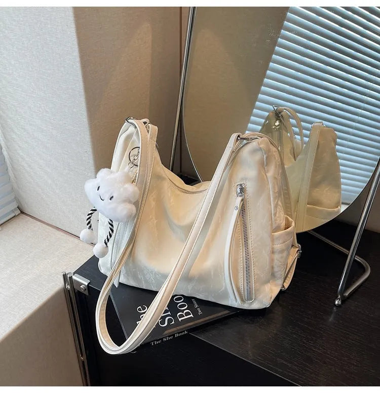 Women's soft PU fashion backpack in four colour options with pendant accessory
